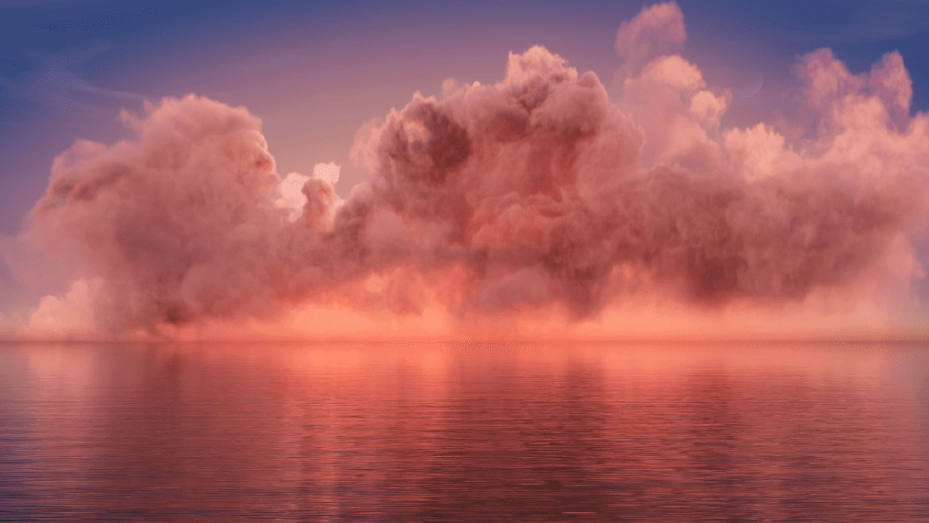 A serene body of water reflects a vivid display of clouds at sunset. The clouds are illuminated in hues of pink, orange, and purple, creating a dramatic and peaceful scene. The sky transitions smoothly from the warm colors of the sunset to the calm blues of the approaching night.