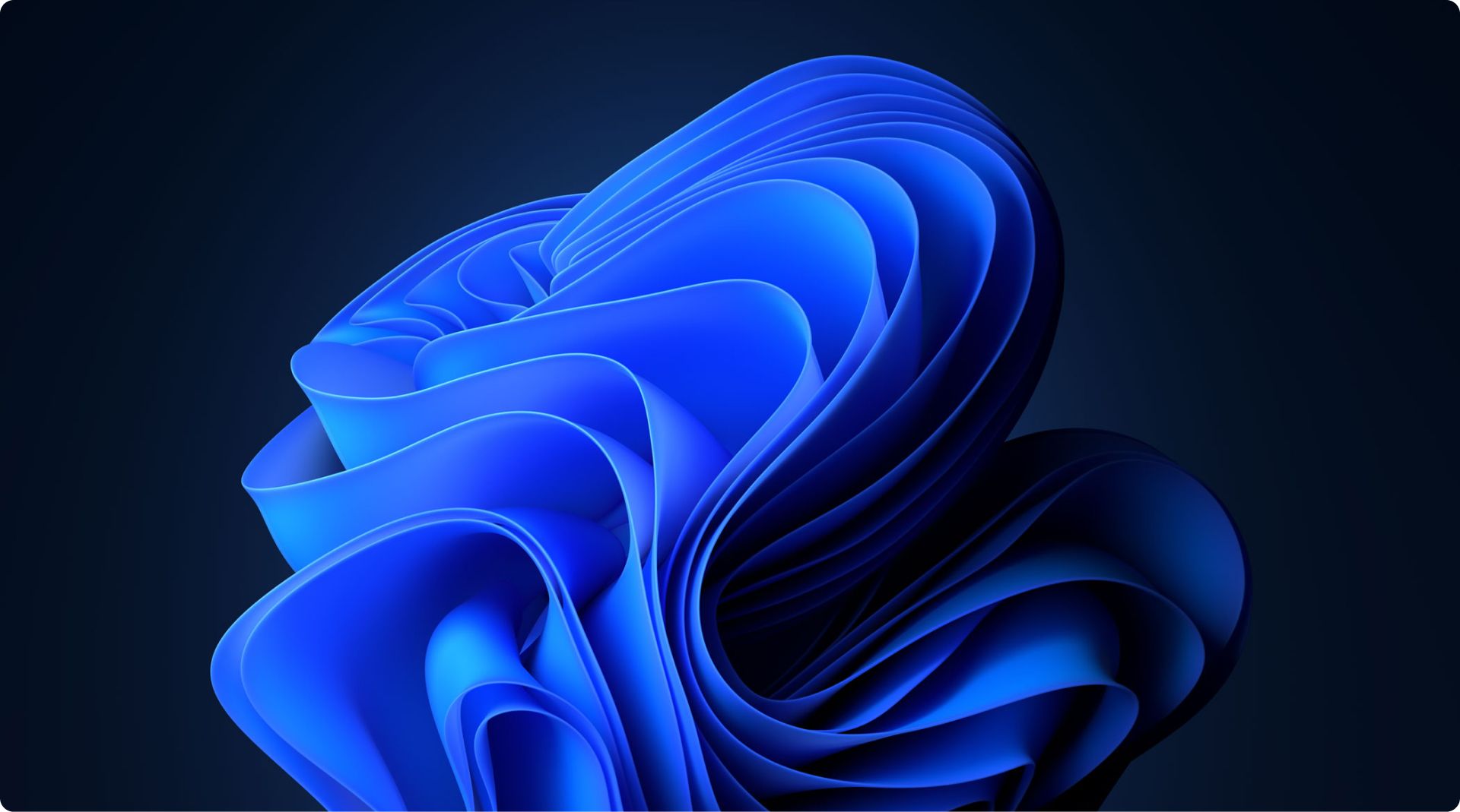 Abstract image featuring a swirling, layered blue design against a dark background. The shapes resemble smooth, flowing fabric or ribbons, with intricate folds and a gradient effect. The overall composition provides a sense of motion and depth.