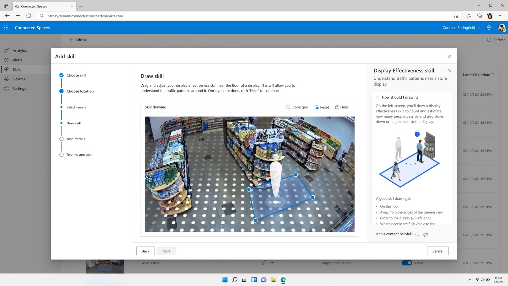 A computer screen displays a tutorial on how to draw and analyze the effectiveness of in-store displays using an overhead camera image of a store aisle. The user is being guided to draw a skill zone on the display image for analysis.