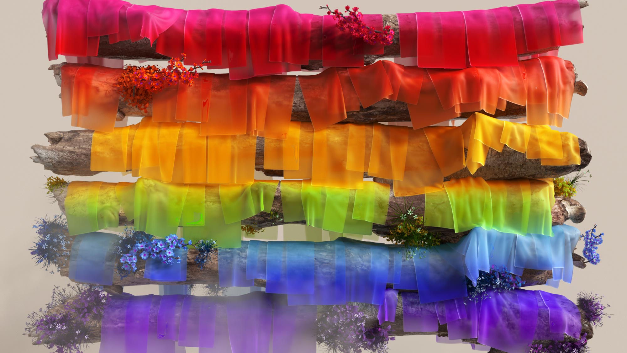 A series of logs arranged horizontally, each adorned with multicolored translucent fabrics in shades of red, orange, yellow, green, blue, and purple. Vibrant flowers in matching colors complement the fabrics, creating a rainbow-like display.