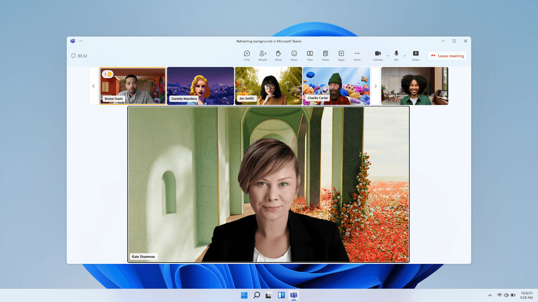 A screenshot of a Microsoft Teams video meeting on a Windows 11 desktop display. Participants' video feeds are shown at the top in a grid, with one person's video prominently displayed in the center. The meeting toolbar is visible at the top of the screen.