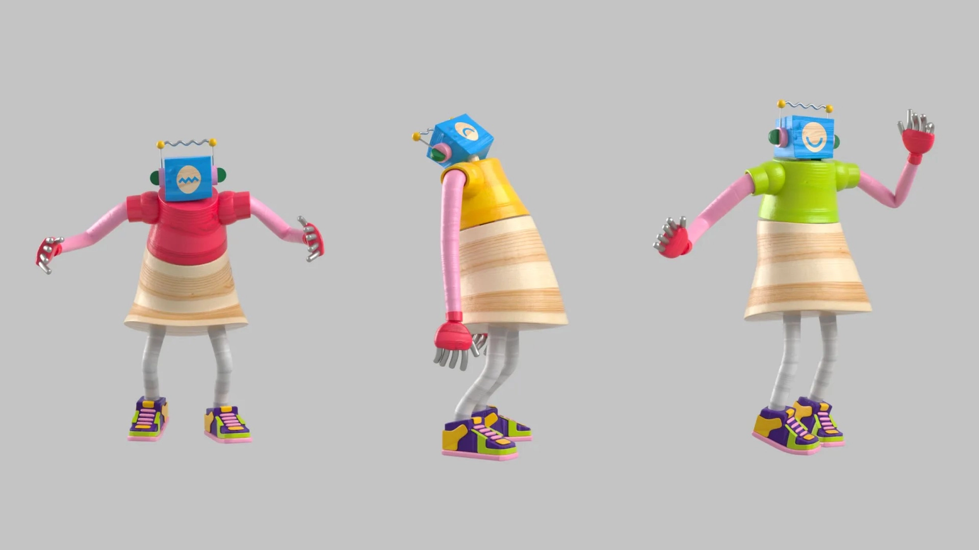 Three colorful robot characters stand against a plain background. Each robot has a box-shaped head with different face designs, pink arms, skirt-like attachments, and colorful sneakers. They are posed in varied, playful positions.