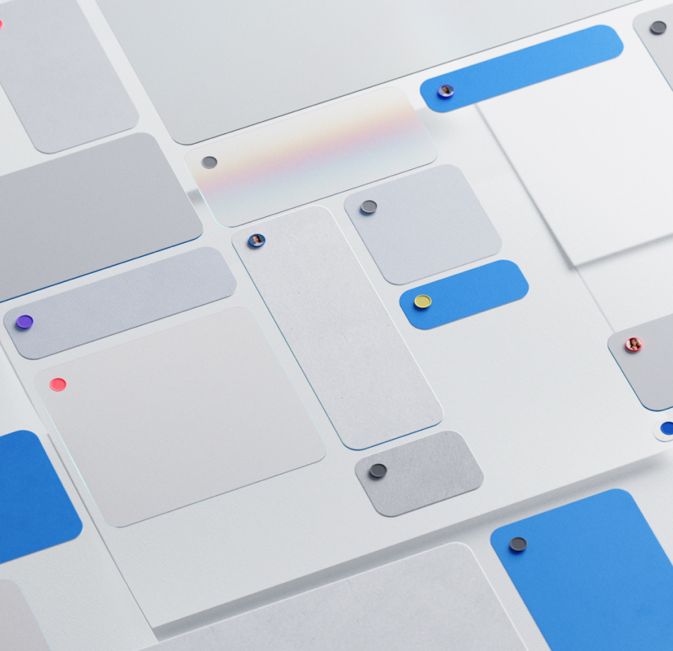 A graphic design featuring various overlapping rounded rectangles in shades of blue, gray, and white. Each rectangle has a small, colorful pin in a corner, creating a layered, abstract layout.