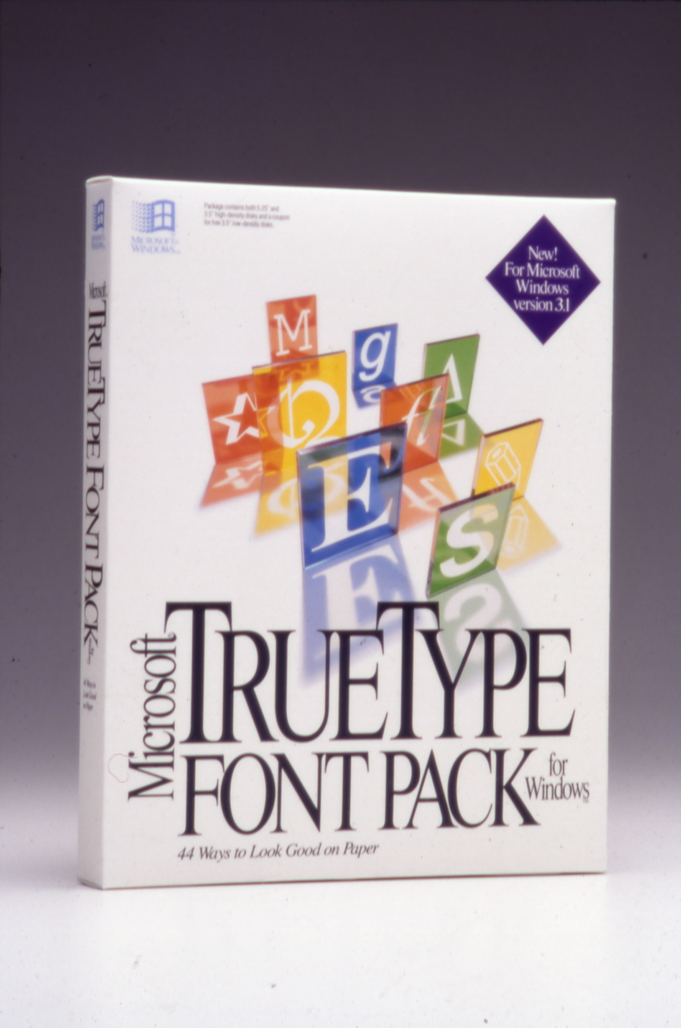 A white software box for "Microsoft TrueType Font Pack for Windows" featuring colorful 3D letter blocks and large, elegant black text on the front. A purple badge states, "New! For Microsoft Windows version 3.1.