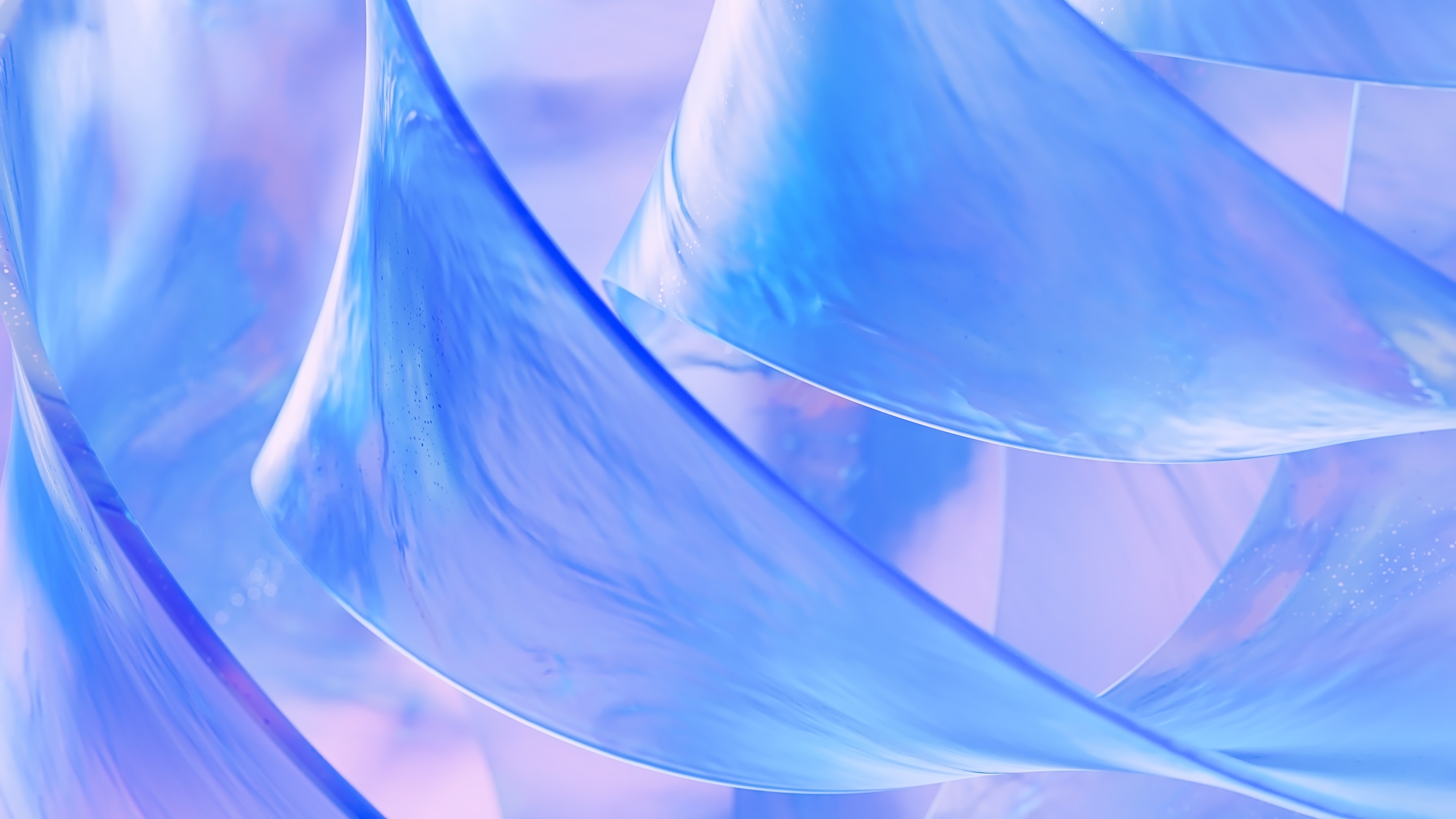 Translucent, wavy blue shapes overlap against a soft, blurred pastel background. The image has an abstract, fluid appearance with light reflections and smooth gradients of blue and purple tones.