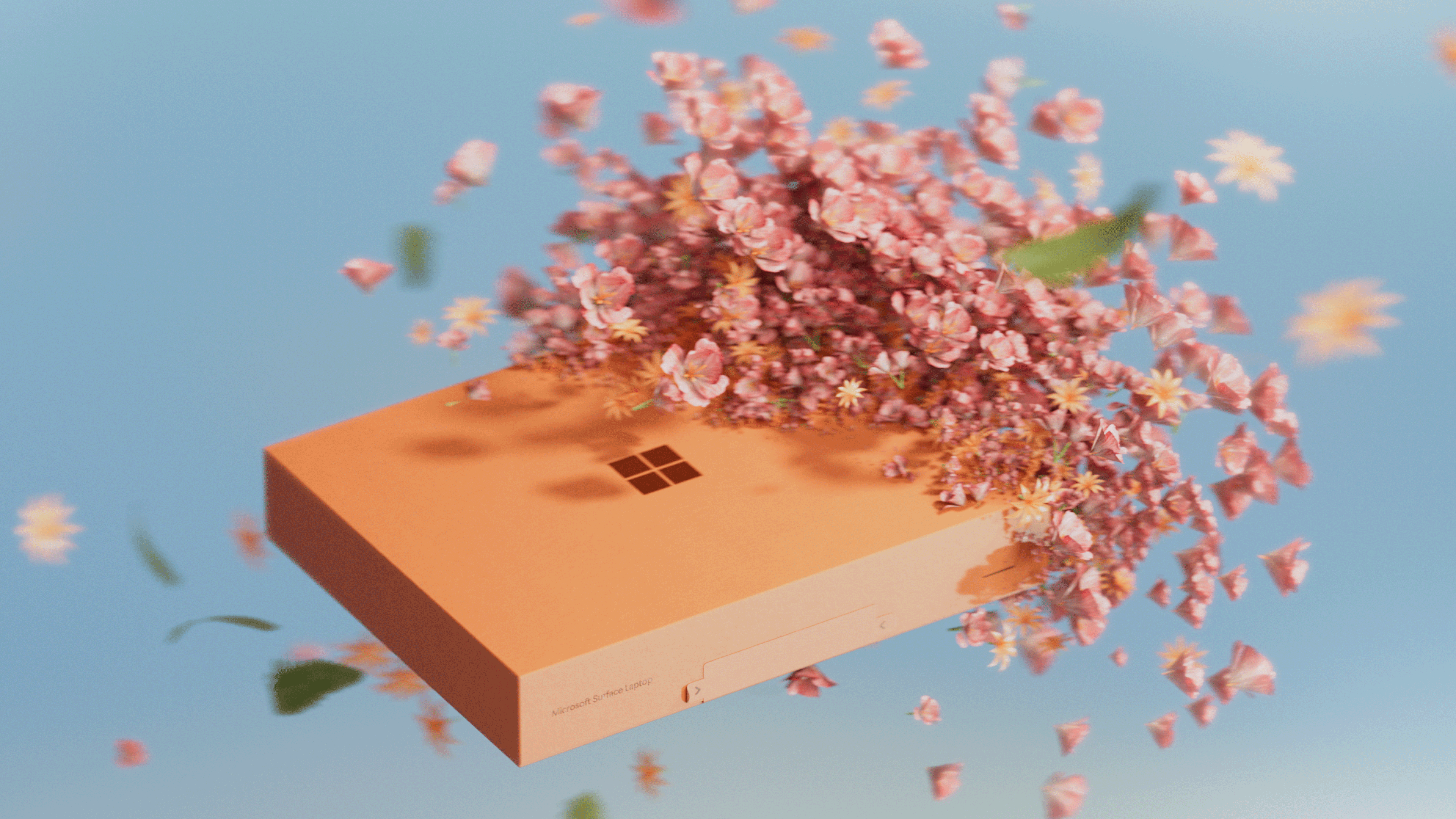 An orange box with the Microsoft logo floats against a blue background, with pink flowers and petals bursting out from the top, creating a dynamic, spring-like effect.