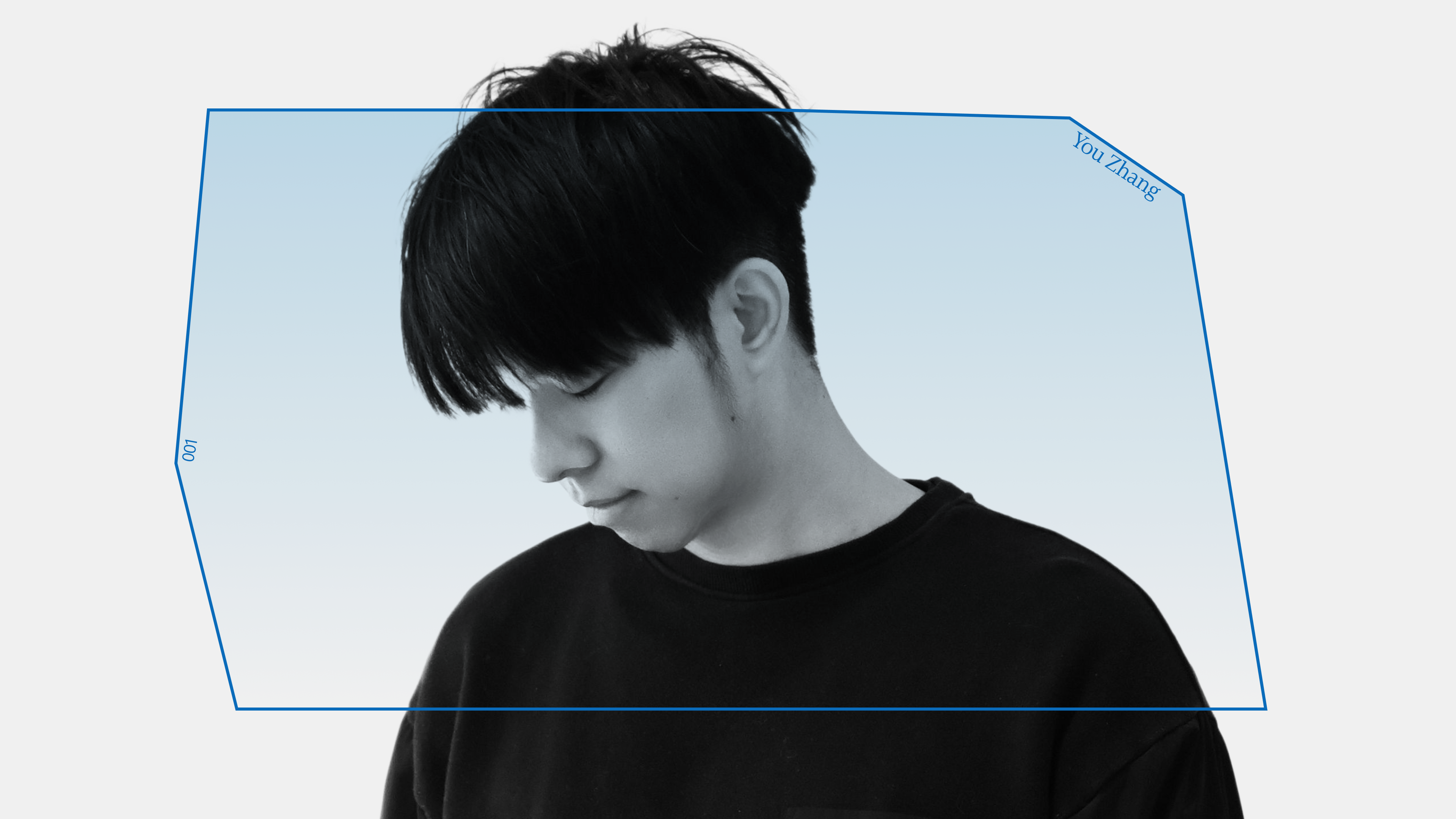 A person with short dark hair looks downward, wearing a black top. The background is white with a blue-tinted, irregular polygon shape overlaying the image. The words "You Zhang" appear in small text on the polygon.