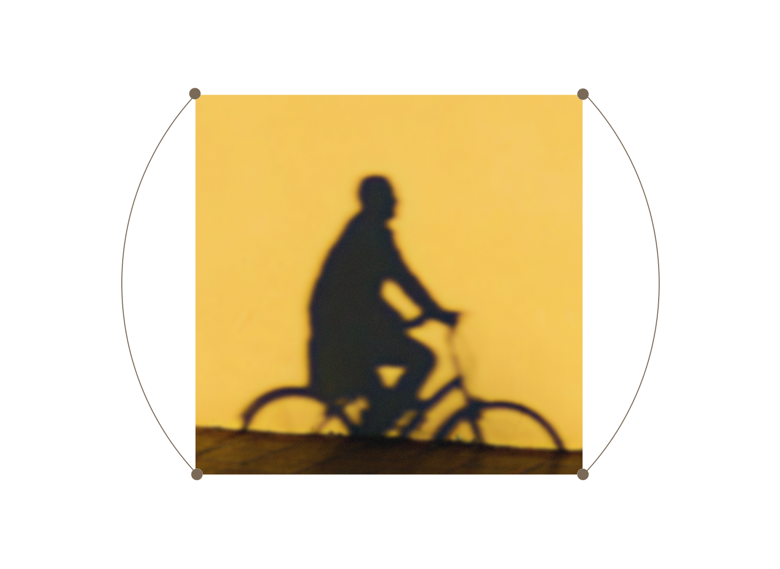 A shadow of a person riding a bicycle is cast against a solid yellow wall, creating a distinct silhouette.